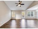 Bright living room featuring hardwood floors, a ceiling fan, and a fireplace at 217 Old Carrollton Rd, Carrollton, GA 30116