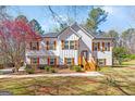 Charming two-story home with white siding, wood shutters, stone accents, and a well-manicured lawn at 275 Cedars Glen Cir, Villa Rica, GA 30180