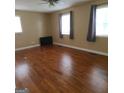 Large bedroom offers multiple windows and classic hardwood flooring throughout at 2563 Highway 81 E, Mcdonough, GA 30252