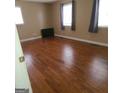 Spacious bedroom features hardwood flooring and plenty of natural light from the windows at 2563 Highway 81 E, Mcdonough, GA 30252