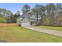 Charming two-story home with a well-maintained lawn, long driveway and attached two-car garage at 205 Valley View Dr, Tyrone, GA 30290