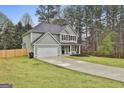 Charming two-story home with a well-maintained lawn, long driveway and attached two-car garage at 205 Valley View Dr, Tyrone, GA 30290