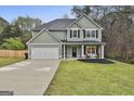 Charming two-story home with a well-maintained lawn and attached two-car garage at 205 Valley View Dr, Tyrone, GA 30290