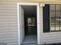 An open door to a home that opens into the living room and sliding glass doors to the back deck at 61 Scoby Ct, Jonesboro, GA 30238