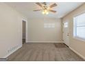 Spacious living room featuring a neutral color palette, plush carpet and a bright front entry door at 3465 Tulip Dr, Decatur, GA 30032