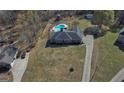 Aerial view of home showcasing backyard pool, fenced yard, mature trees, and extended driveway at 809 Mcbean Ct, Mcdonough, GA 30252
