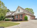 Brick home with white trim and a two-car garage, nestled on a beautifully landscaped lot at 142 Gillson Dr, Mcdonough, GA 30253