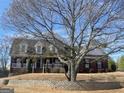 Brick home with a covered porch, situated on a lush lot with mature trees at 142 Gillson Dr, Mcdonough, GA 30253