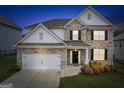 Charming two-story home with well-maintained lawn and landscaping features a two car garage at 4365 Sunflower Cir, Cumming, GA 30040