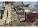 Stone monument displaying the Walker Commons community sign, surrounded by manicured landscaping at 2458 Walker Dr, Hampton, GA 30228
