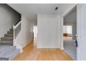 Open entryway featuring hardwood floors, staircase, and access to various rooms at 4542 White Rd, Douglasville, GA 30135