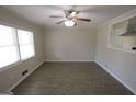 Bright living room with large window and ceiling fan, open to the kitchen at 5784 Sharon Dr, Norcross, GA 30071