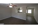 Open-concept living room featuring modern flooring and a kitchen view at 5784 Sharon Dr, Norcross, GA 30071