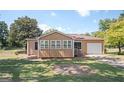 Inviting single-story home with a well-manicured lawn and an attached garage, perfect for comfortable living at 2049 Nancy Se Cir, Smyrna, GA 30080