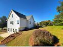 The back of the house features a deck with a large lot surrounded by mature trees at 217 Point Ridge Ct, Temple, GA 30179