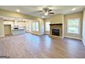 Spacious living room featuring beautiful hardwood floors, a ceiling fan, and a brick fireplace at 217 Point Ridge Ct, Temple, GA 30179
