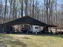 Pole barn with camper, storage and ATV on a grass lot at 4389 & 4381 Campbell Rd, Snellville, GA 30039