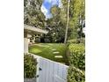 Lush backyard featuring stepping stones and mature trees creating a serene and private outdoor space at 497 Pine Haven Ln, Atlanta, GA 30342