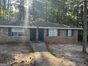 Brick multifamily home with a sidewalk leading to the front doors and green shutters surrounded by trees at 6540 Lower Dixie Lake Rd, Union City, GA 30291