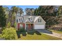 Charming home with a well-manicured lawn and mature trees casting pleasant shadows at 115 Brook Hollow Dr, Mcdonough, GA 30252