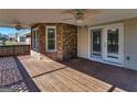Inviting covered back deck made of wood with ceiling fans and brick accents at 105 Overlook Dr, Mcdonough, GA 30252