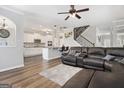 Inviting living room seamlessly connected to the kitchen and staircase with hardwood floors and stylish decor at 1734 Tricklin Spgs, Mcdonough, GA 30252