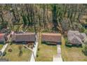 Aerial view shows a neighborhood with single-Gathering homes with mature trees and well-manicured lawns at 447 Wavelyn Way, Riverdale, GA 30274