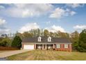 Charming, single-story brick home featuring a two-car garage and dormer windows at 237 Summerford Pl, Stockbridge, GA 30281