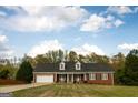 Charming, single-story brick home featuring a two-car garage and dormer windows at 237 Summerford Pl, Stockbridge, GA 30281