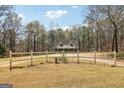Spacious lot with a charming home and white fencing providing privacy and curb appeal at 375 Wellington Mill Rd, Whitesburg, GA 30185