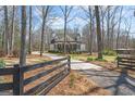 Long driveway leading up to a charming home with a black fence for added curb appeal at 595 S Antioch Rd, Mcdonough, GA 30252