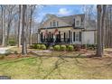 Well-maintained home with a welcoming front porch, black shutters, and attractive landscaping at 595 S Antioch Rd, Mcdonough, GA 30252