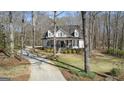 Beautiful home with a long drive, manicured lawn, and a lovely front porch at 595 S Antioch Rd, Mcdonough, GA 30252