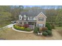 Aerial view of a well-maintained home with mature trees and a curved driveway at 308 Tussahaw Trl, Locust Grove, GA 30248