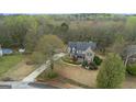 Aerial view showing a home situated on a lot with mature trees and long driveway at 308 Tussahaw Trl, Locust Grove, GA 30248