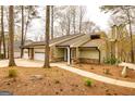 Charming home with stone accents, lush landscaping, and a long driveway at 171 Rockspray Rdg, Peachtree City, GA 30269