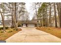 Charming home with a three-car garage, wooded landscaping, and long driveway at 171 Rockspray Rdg, Peachtree City, GA 30269