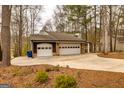 Charming home featuring a three-car garage surrounded by wooded landscaping at 171 Rockspray Rdg, Peachtree City, GA 30269
