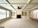Spacious living room featuring custom built-in shelving, fireplace, and coffered ceiling at 3393 Willow Glen Trl, Suwanee, GA 30024