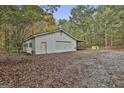 Spacious garage with a car port and a roll up door on a tree covered lot at 3530 Highway 81 W, Hampton, GA 30228