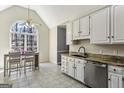 Cozy kitchen with white cabinets, granite countertops, and a view of the trees at 5163 Holly Springs Dr, Douglasville, GA 30135