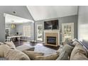 Bright living room features a fireplace, hardwood floors, and a comfortable seating area at 5163 Holly Springs Dr, Douglasville, GA 30135