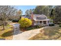 Gorgeous aerial shot of a home with a long driveway, lush landscaping, and inviting front porch at 135 Horseshoe Cir, Fayetteville, GA 30215