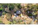 Beautiful aerial shot showcases a home surrounded by mature trees, highlighting its private setting at 135 Horseshoe Cir, Fayetteville, GA 30215