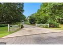 Long driveway leads to a charming home surrounded by lush greenery at 135 Horseshoe Cir, Fayetteville, GA 30215