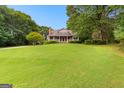 Expansive front lawn leading to a home with a welcoming front porch at 135 Horseshoe Cir, Fayetteville, GA 30215