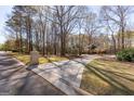 Idyllic long driveway leads to a private home nestled in a picturesque wooded setting at 115 Flagstop Run, Fayetteville, GA 30215