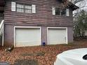 Rear exterior view featuring attached two car garage with white doors at 191 Charles Cox Dr, Canton, GA 30115