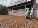 Exterior back view of split level home featuring a covered porch with white railings at 191 Charles Cox Dr, Canton, GA 30115
