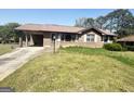 Charming single story brick home with carport and front yard featuring an easy to maintain lawn at 2574 Rosedale Dr, Morrow, GA 30260